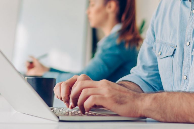 Man and woman are working on a laptop